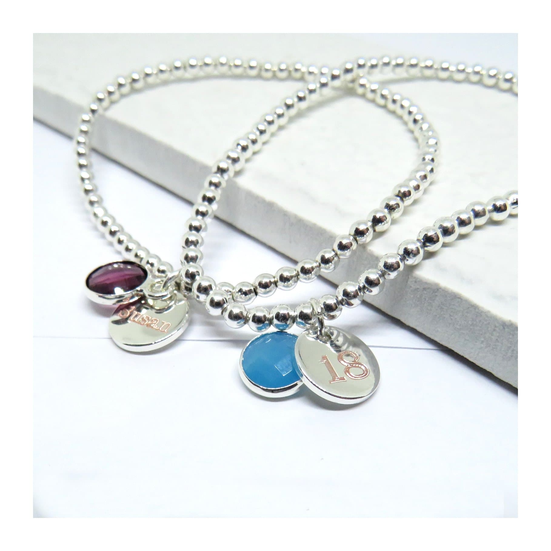 Silver beaded bracelet with a coloured birthstone and a silver disc charm