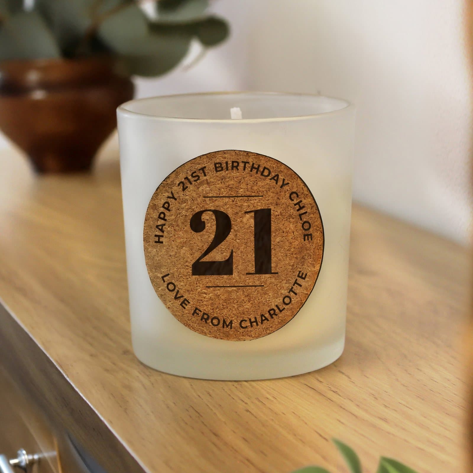 Vanilla jar candle with a cork label showing an age and birthday message