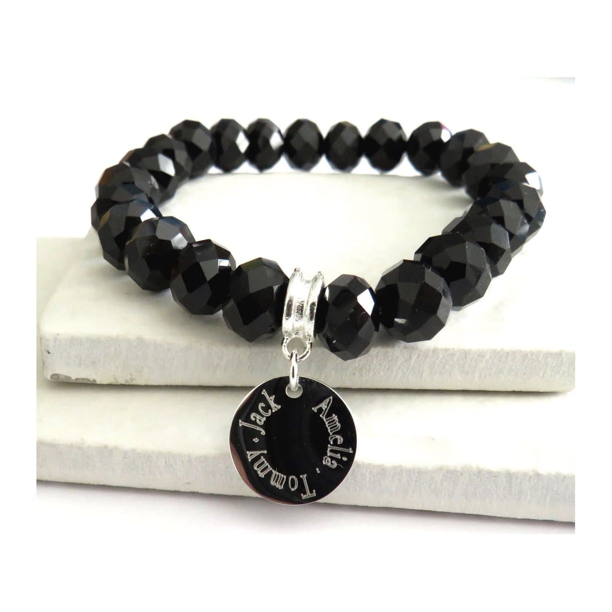 Black glass crystal beaded stretch bracelet with a round silver charm