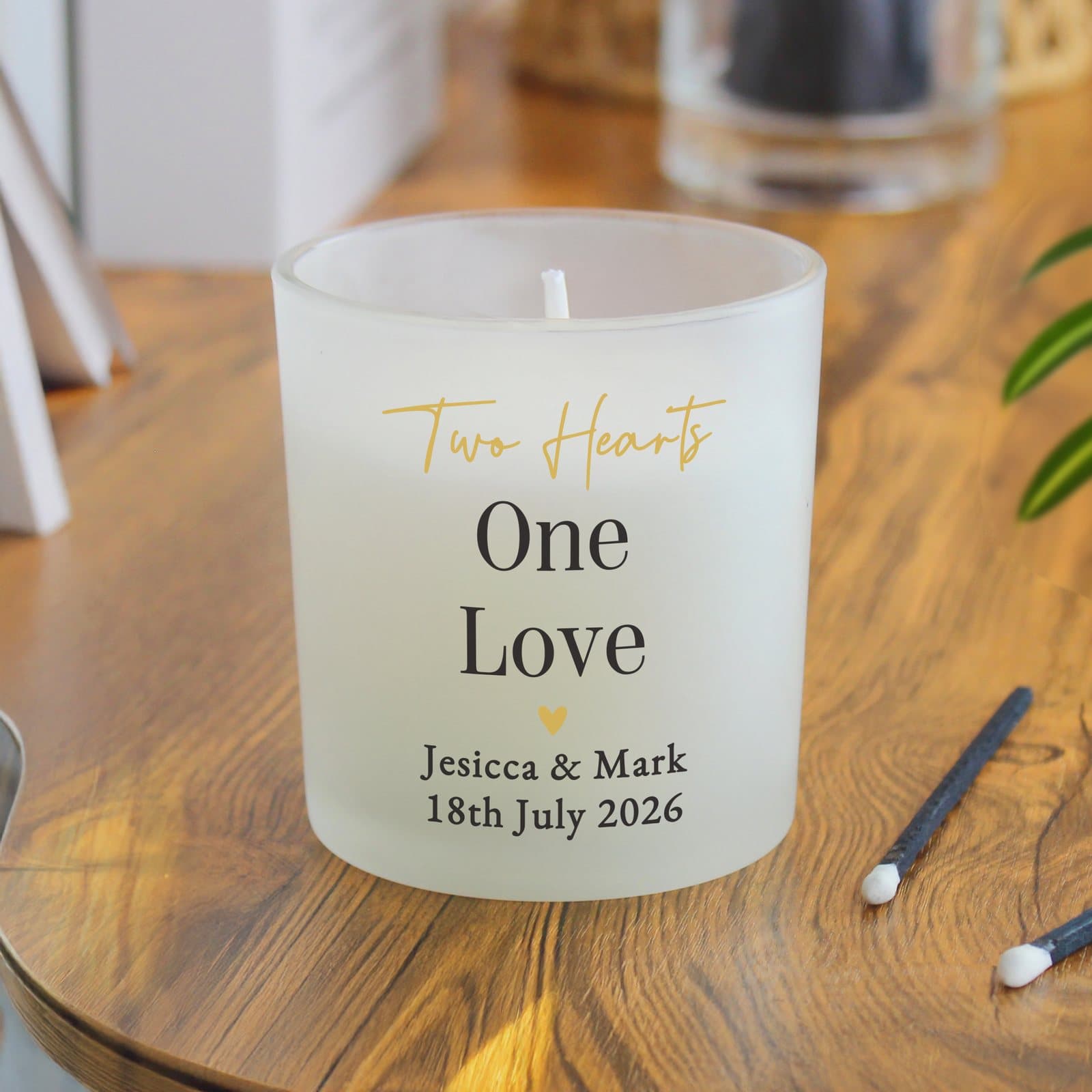 Personalised black and gold frosted candle with lines of custom text