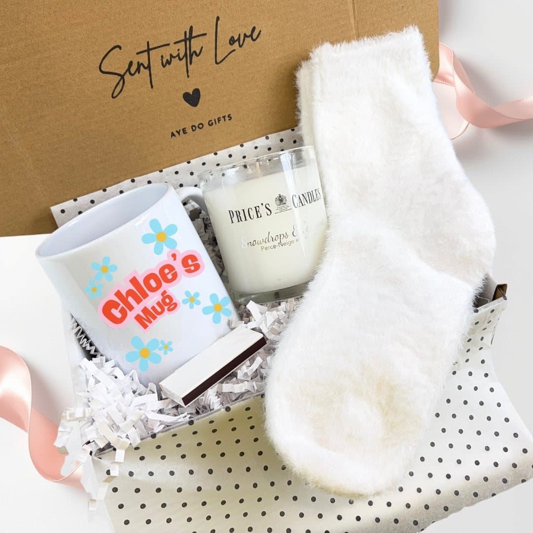 Personalised blue daisy mug with a scented candle, fluffy socks and matches