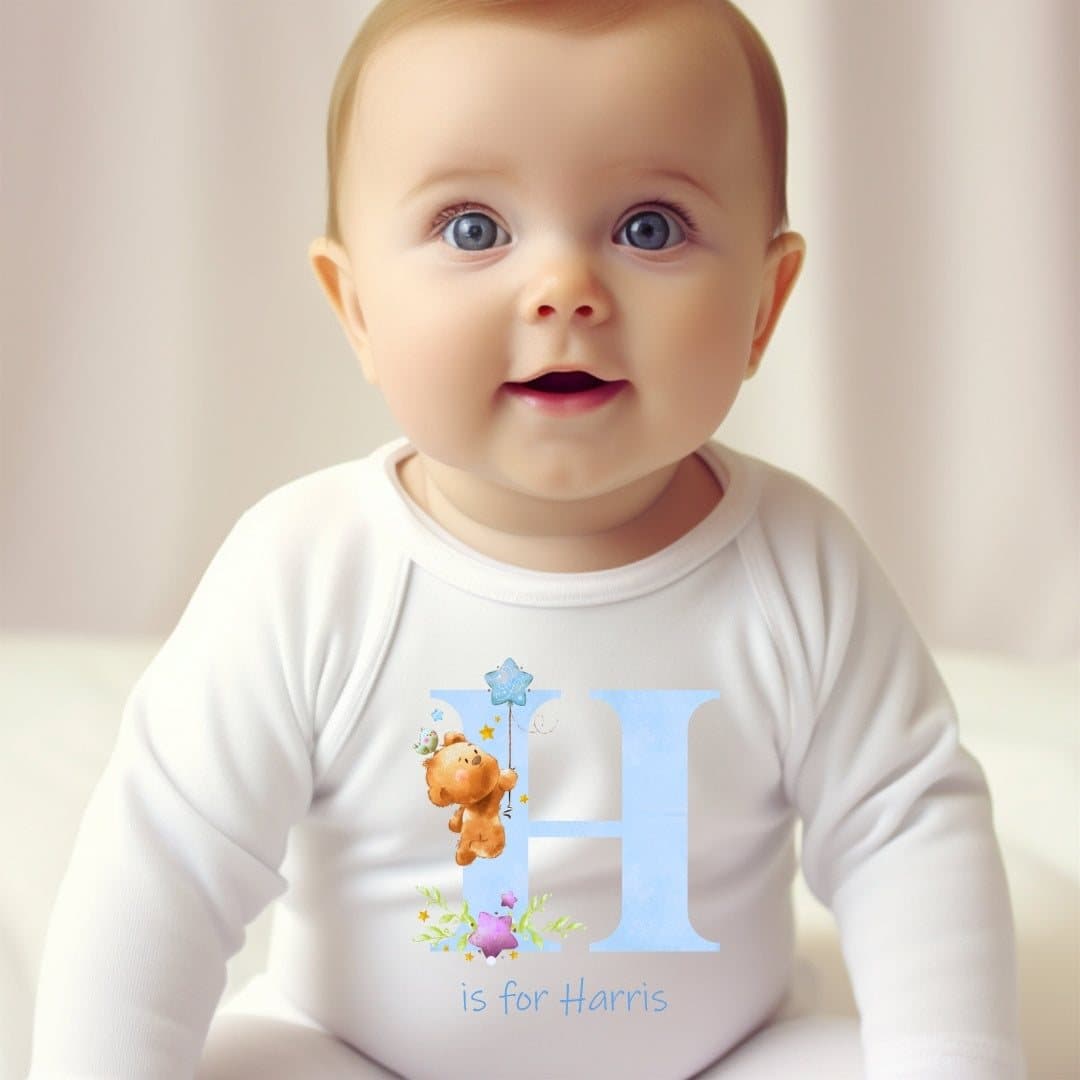 Blue teddy baby outfit with initial artwork, personalised with a name