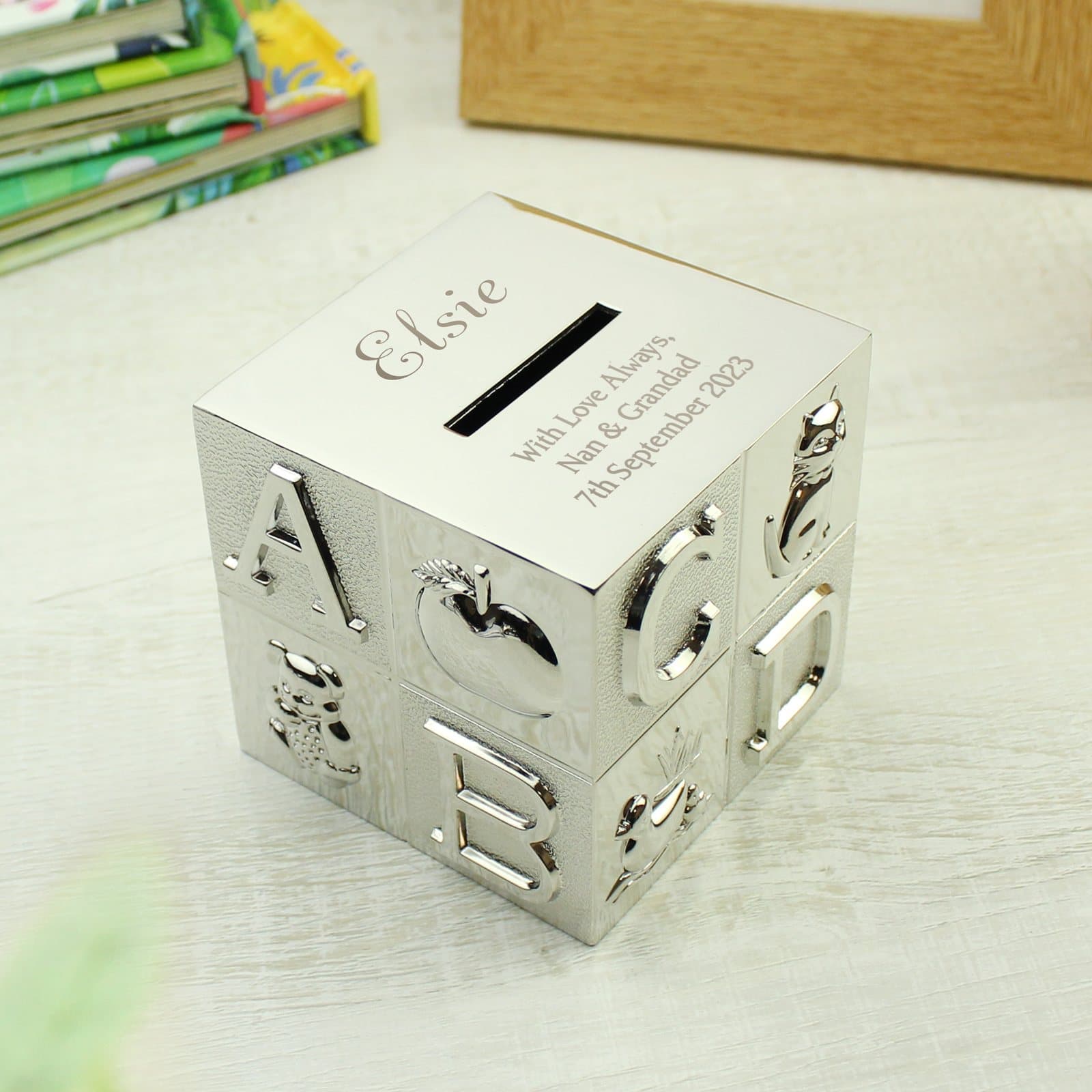 Square ABC money box engraved with a name above the money slot