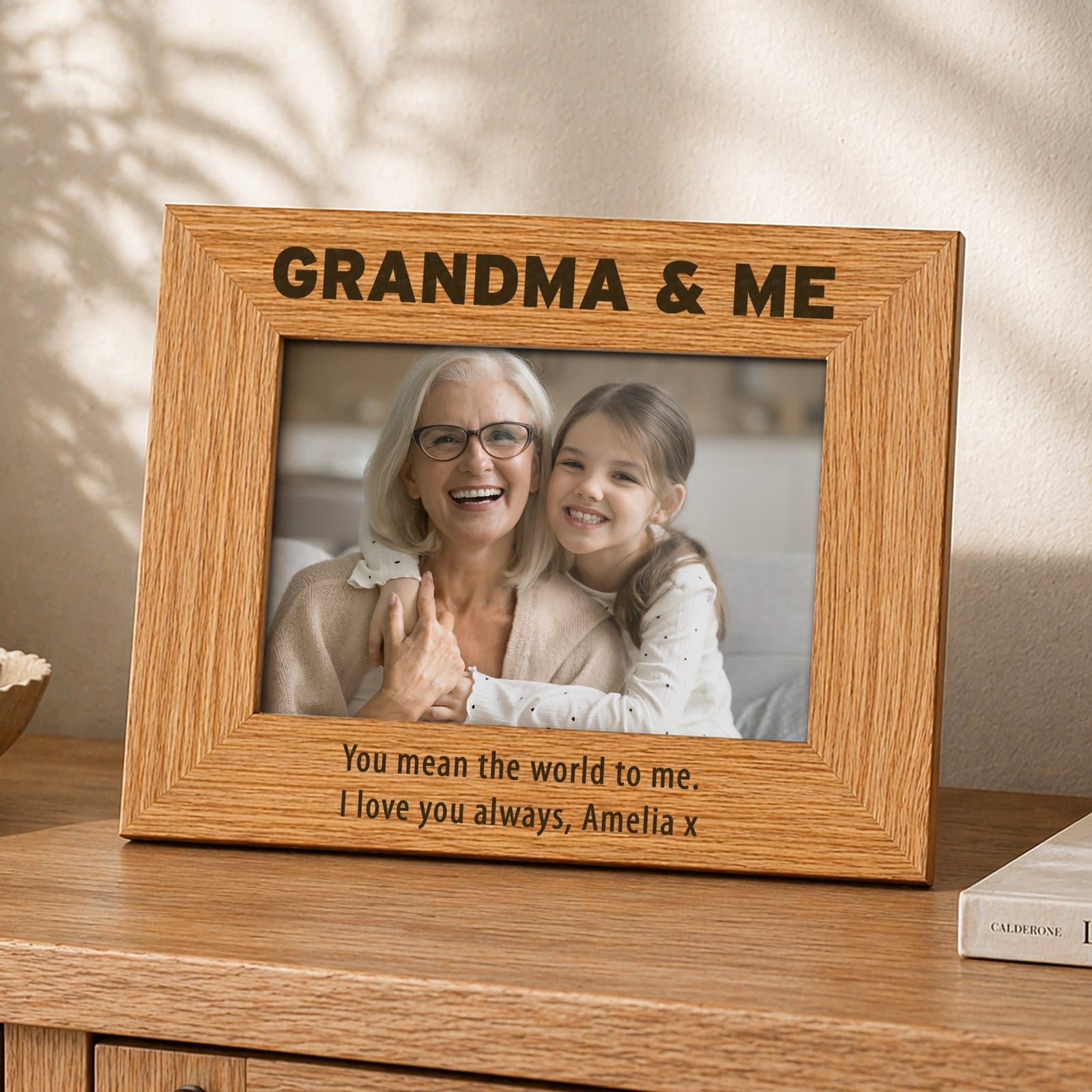 Oak veneer wooden photo frame with bold text above and two lines below the photo