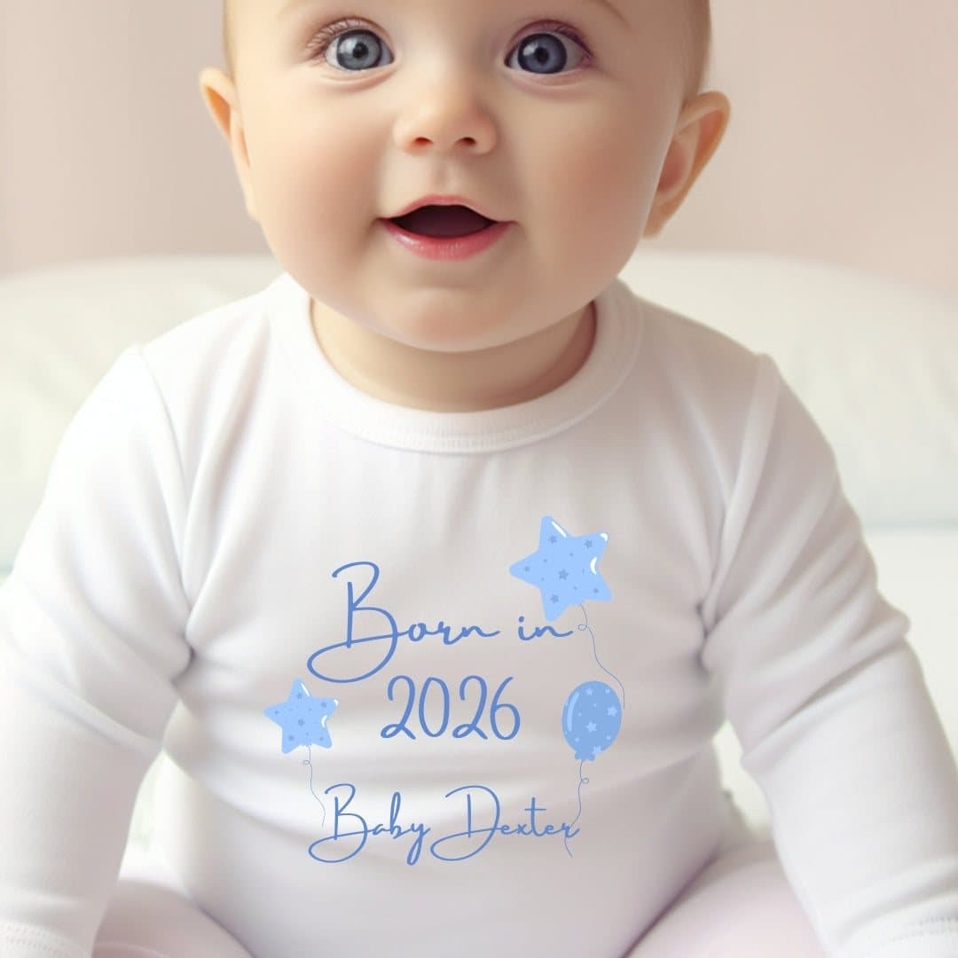 Blue balloon Born in 2026 design on a baby outfit with a name