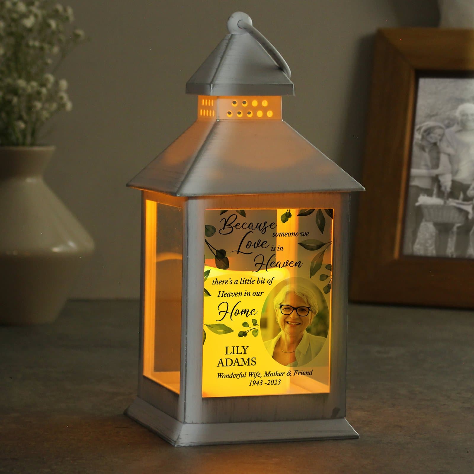 White memorial lantern with a flame effect, a photo and lines of text