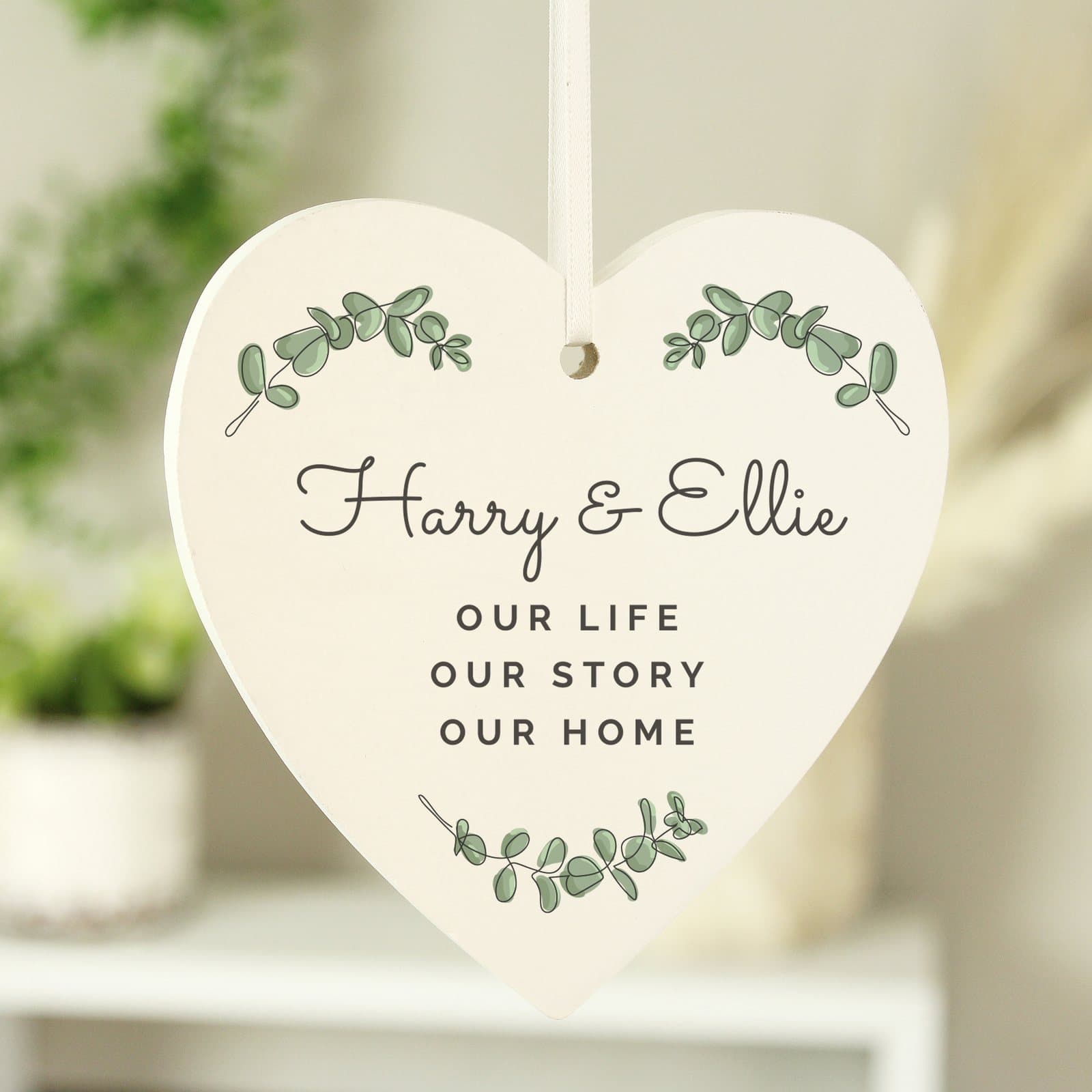 Personalised botanical wooden heart decoration with ribbon and four lines of text