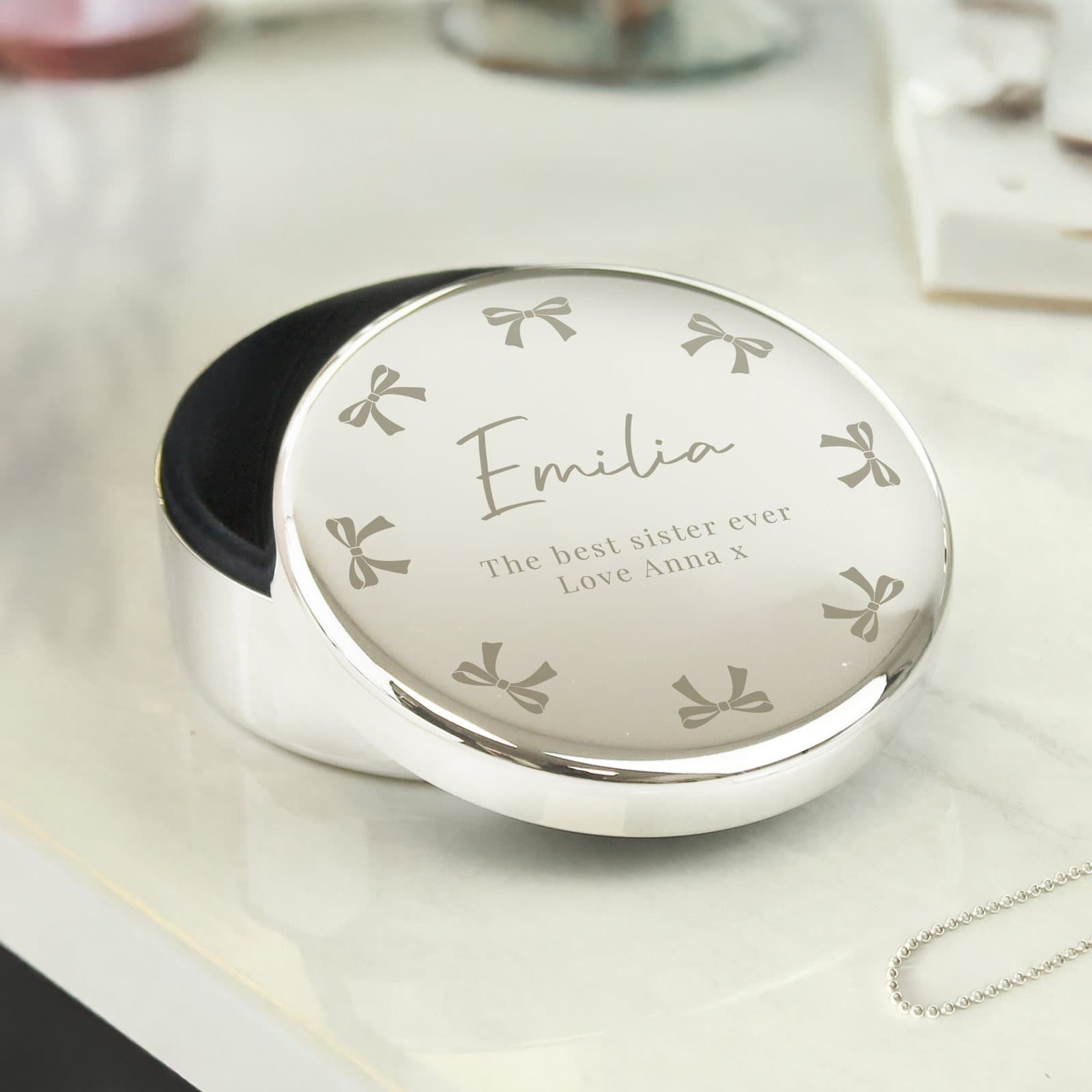 Nickel plated round trinket box with a bow