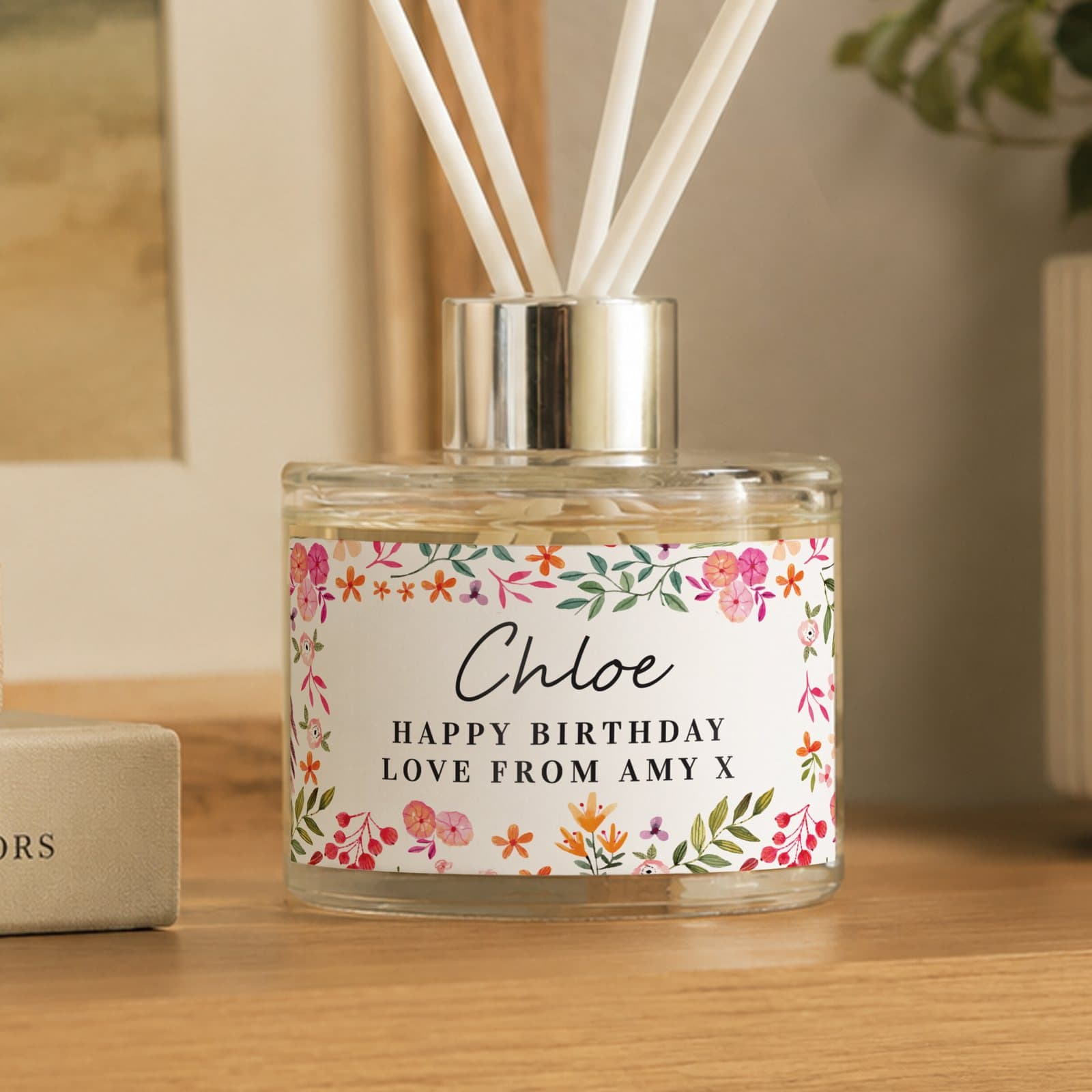 Personalised bright floral glass reed diffuser with three lines of text