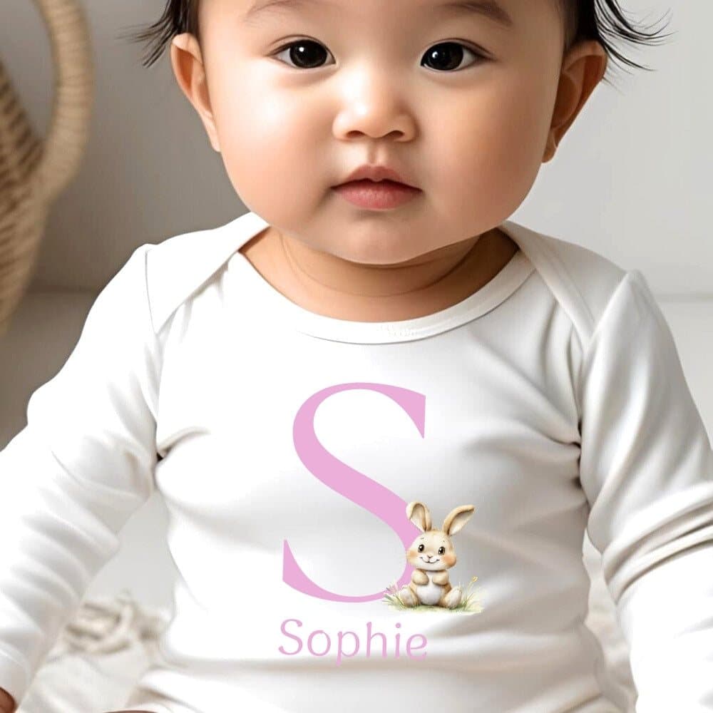 Personalised pink bunny baby outfit with a pink name and initial
