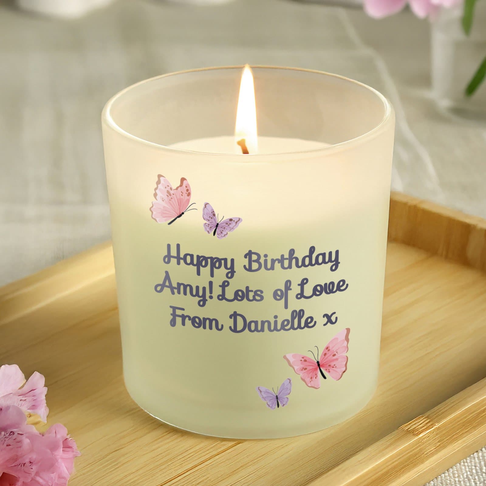 Frosted candle with a butterfly design and personalised lines of text