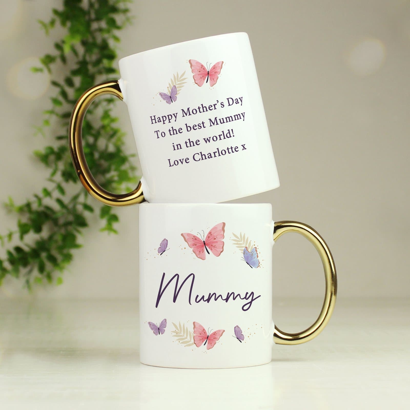 Ceramic butterfly mug with a gold handle and a personalised name