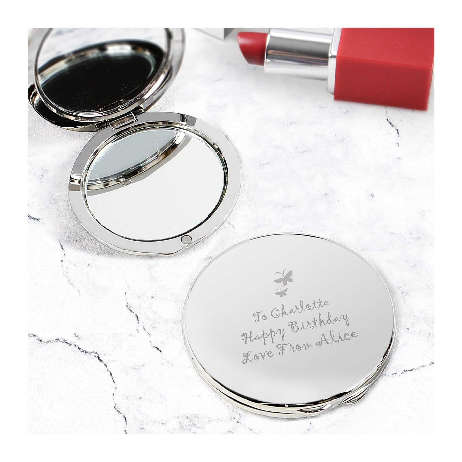 Round silver finish compact mirror with a butterfly motif