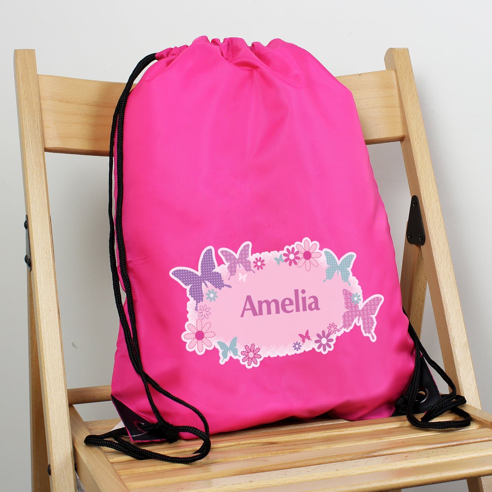 Pink drawstring swim bag with a butterfly design and a personalised name