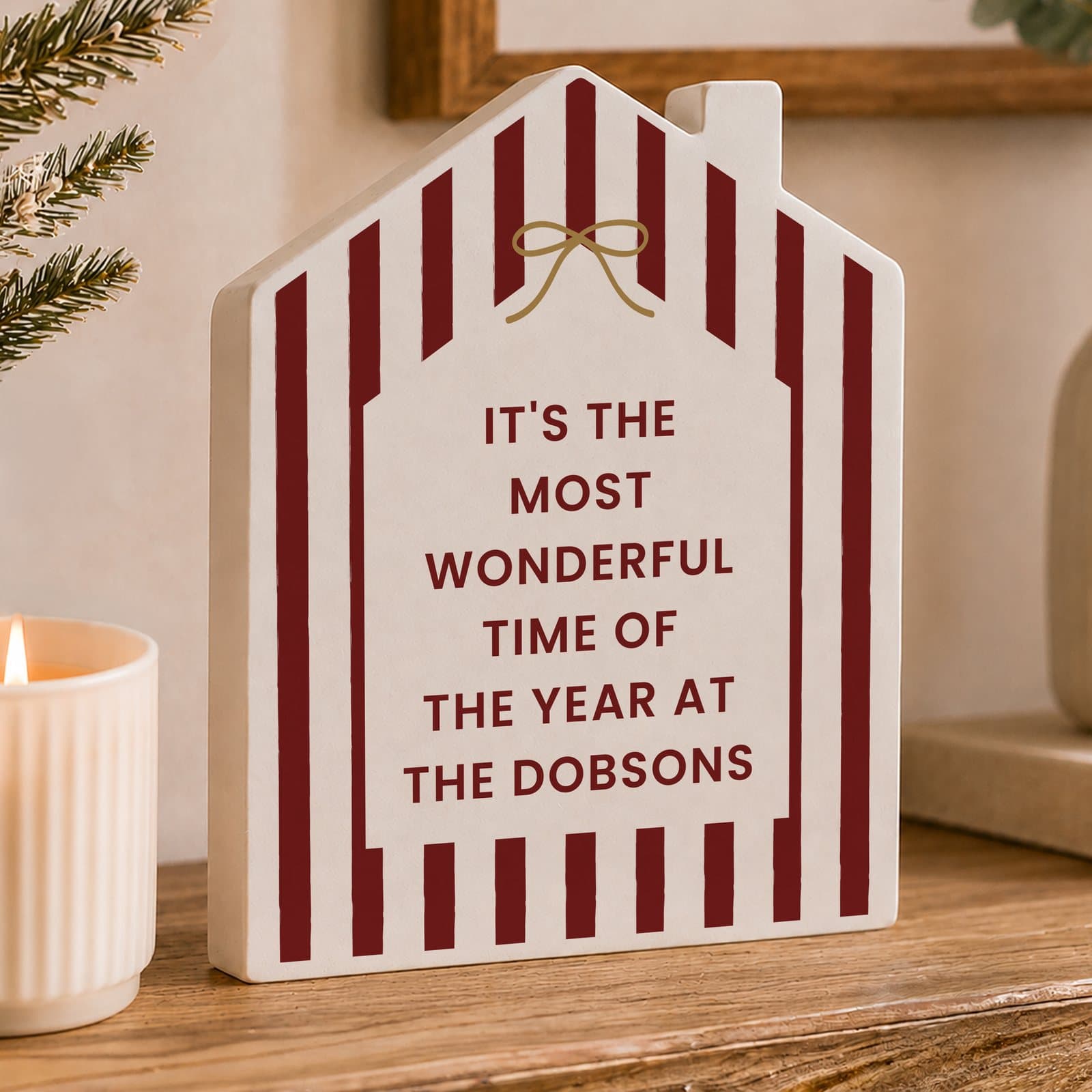 Wooden house ornament with a candy cane stripe design and personalised lines of text