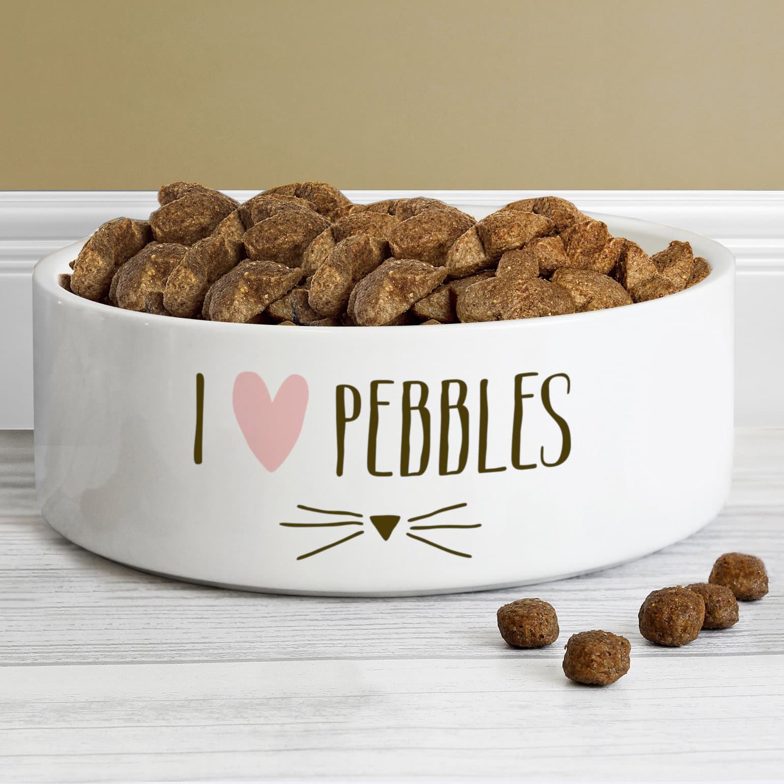 White ceramic pet bowl with a cat features design and a name
