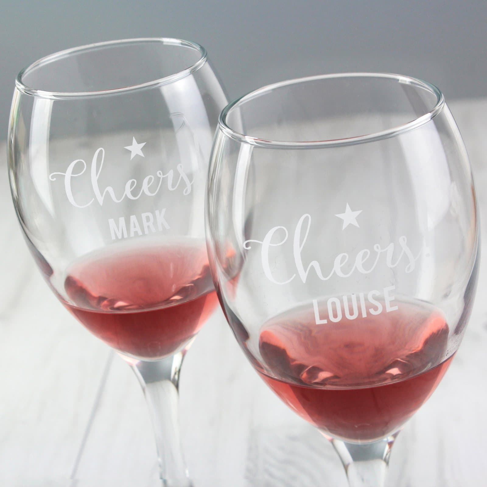 Set of two personalised Cheers wine glasses with a name on each