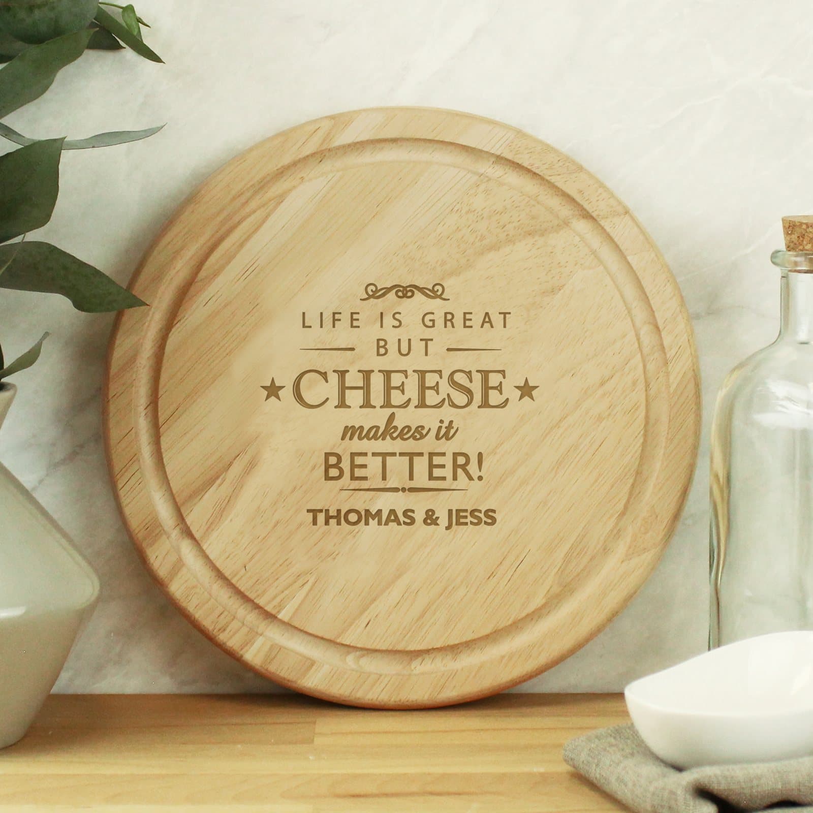 Round personalised wooden cheese board with cheese slogan and a line of text