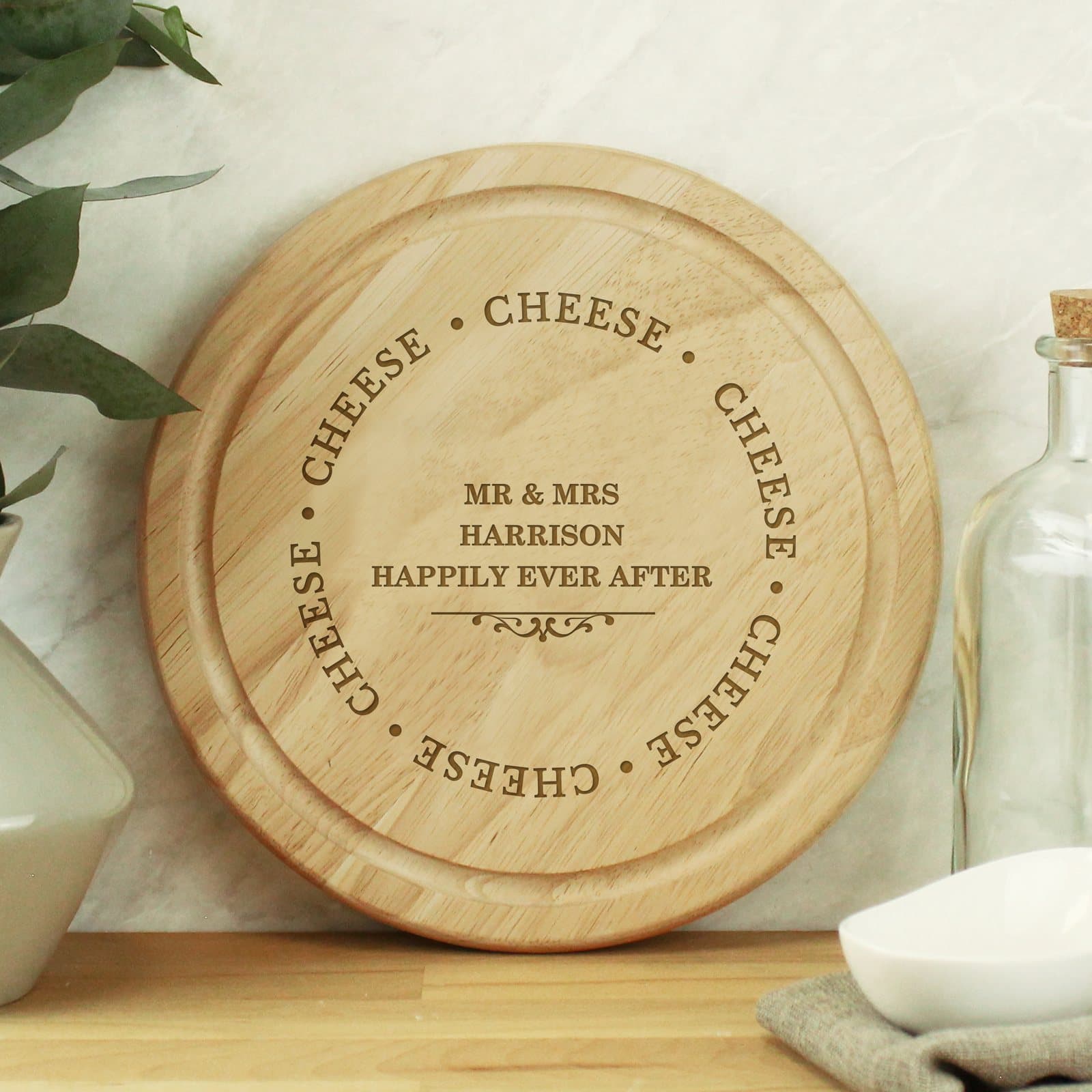 Round wooden cheese board with Cheese around the outside and personalised lines