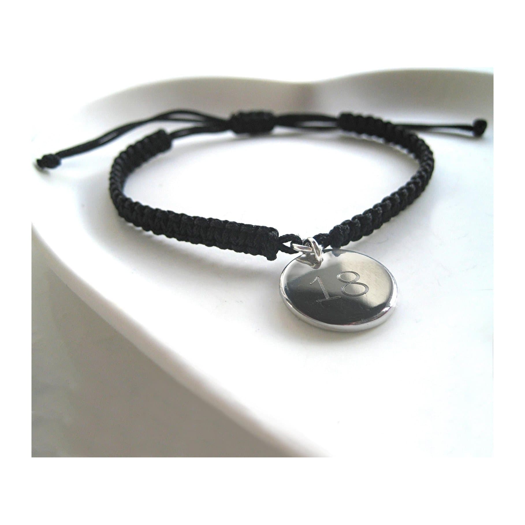 Braided nylon friendship bracelet with a polished stainless steel engraved disc