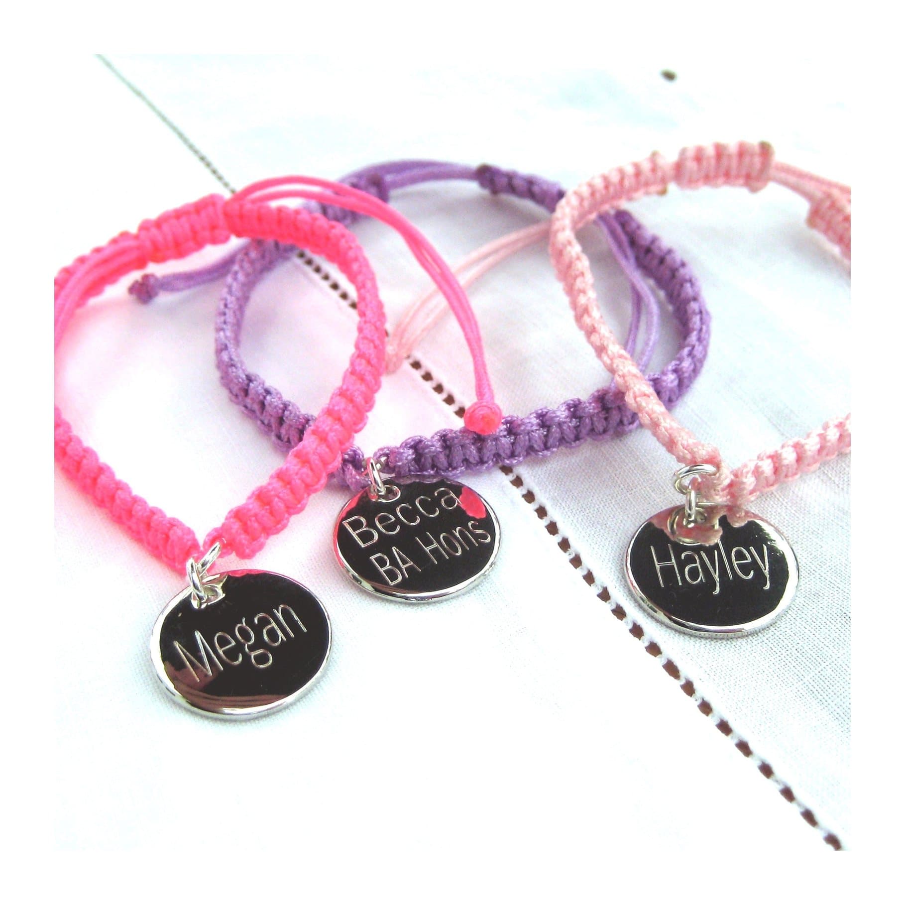 Braided nylon friendship bracelet with a silver coloured name disc