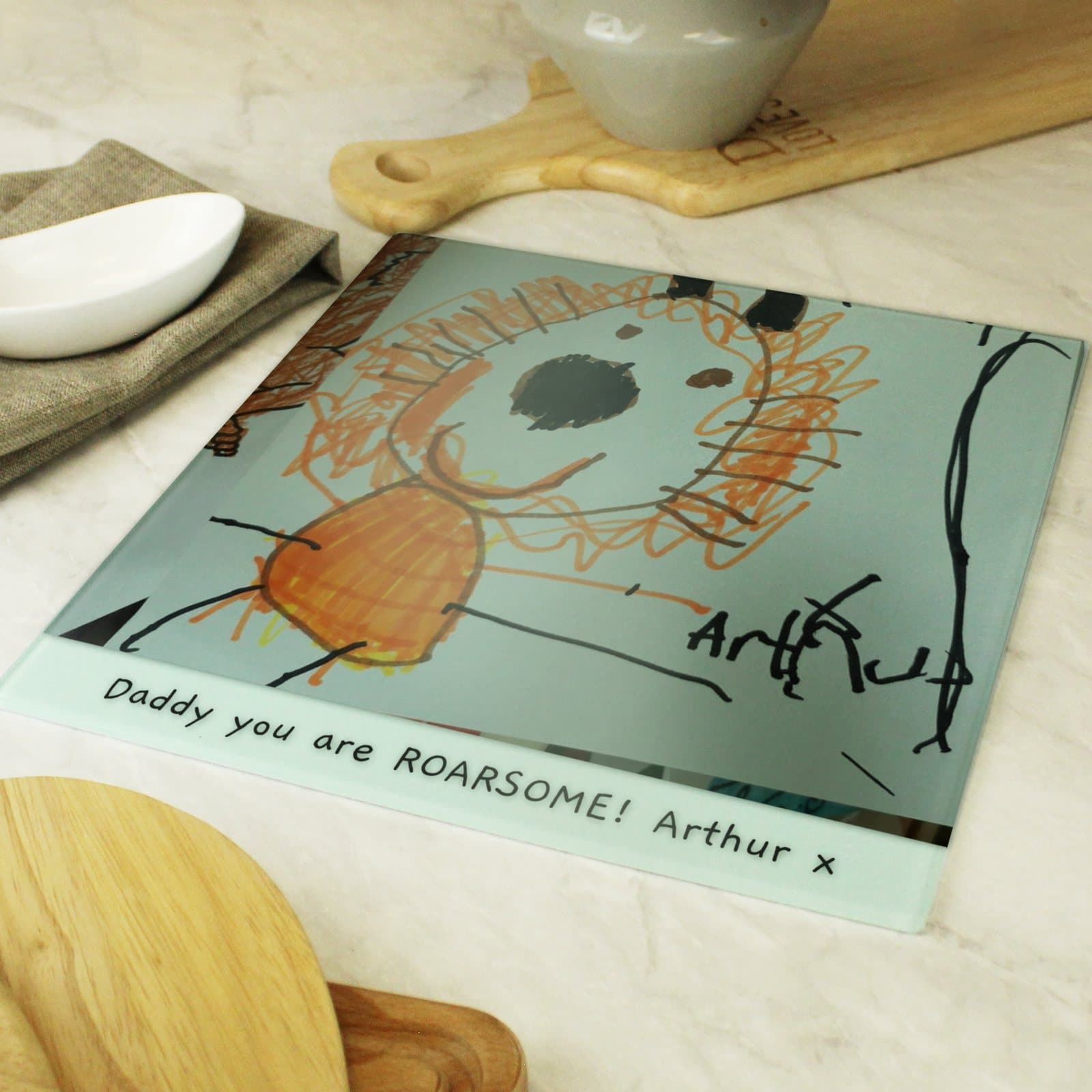 Glass chopping board personalised with a child's drawing and a line of text