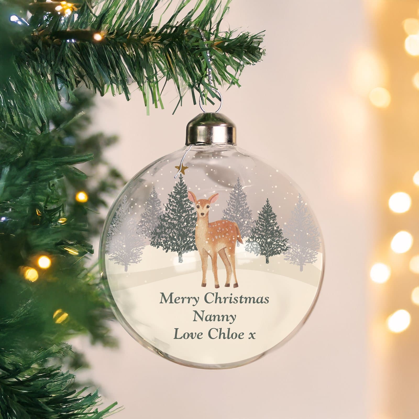 Glass Christmas bauble with a reindeer design and three lines of personalised text