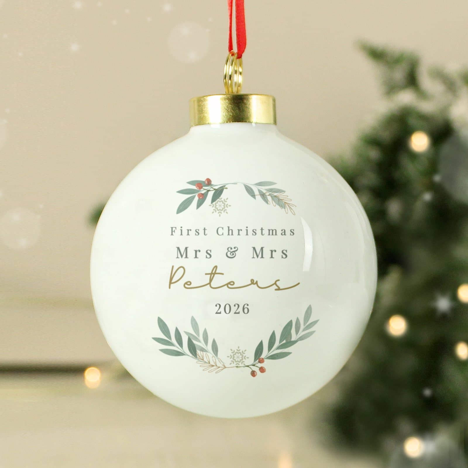 Christmas bauble with a foliage design, personalised message and a hanging ribbon