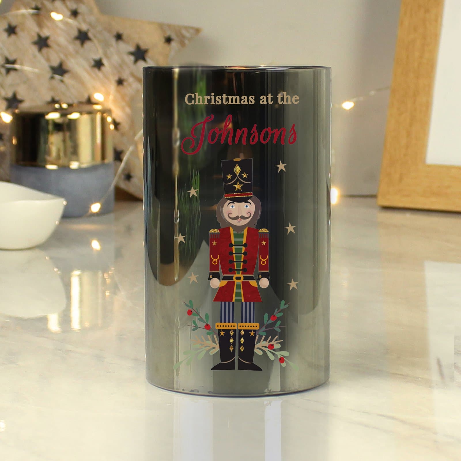 Smoked frosted glass LED candle with a nutcracker-inspired design and amber flame