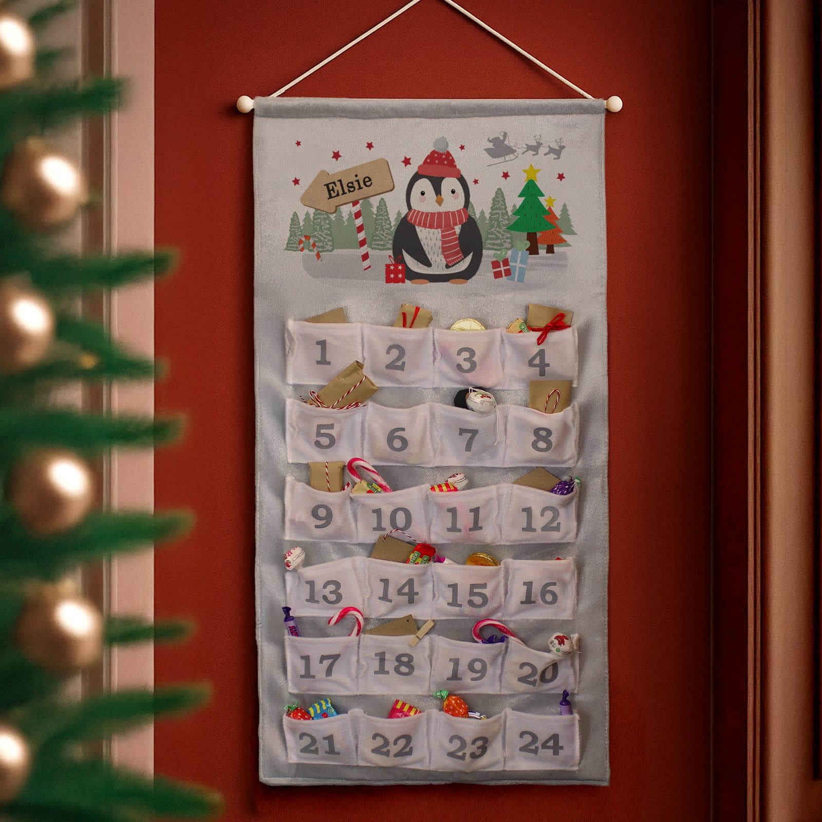 Silver grey penguin advent calendar with numbered pockets and a personalised name
