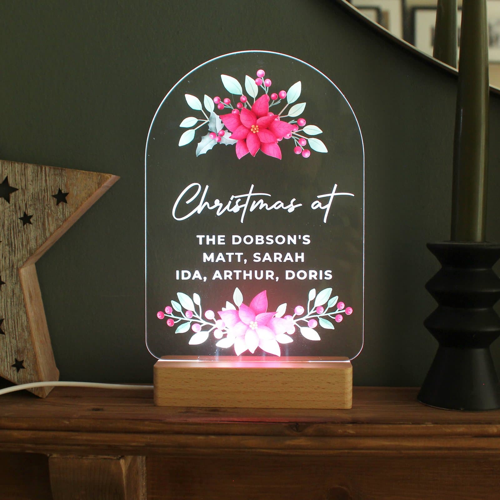Poinsettia LED sign on a wooden base with personalised text