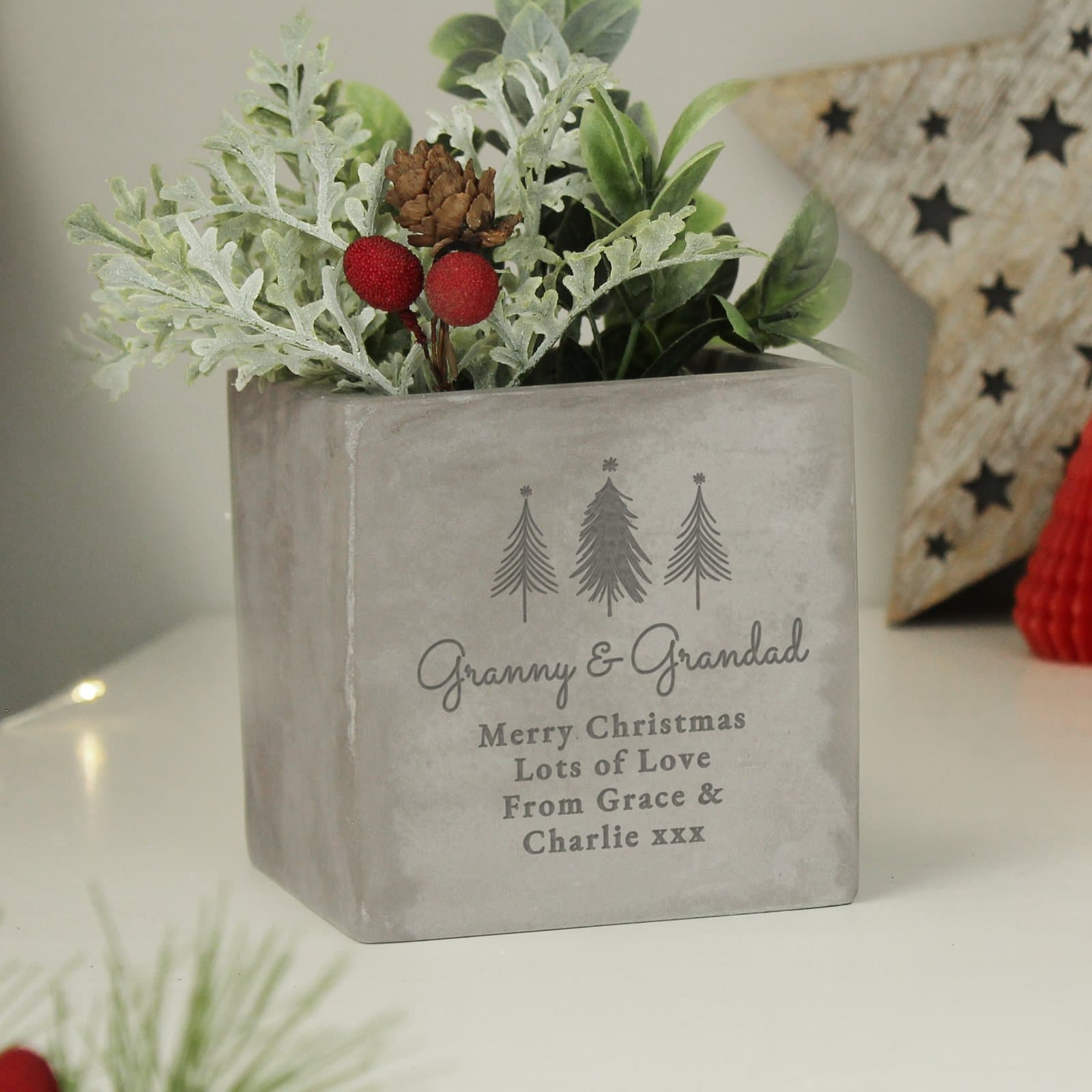 Concrete planter with a Christmas tree design and personalised lines of text