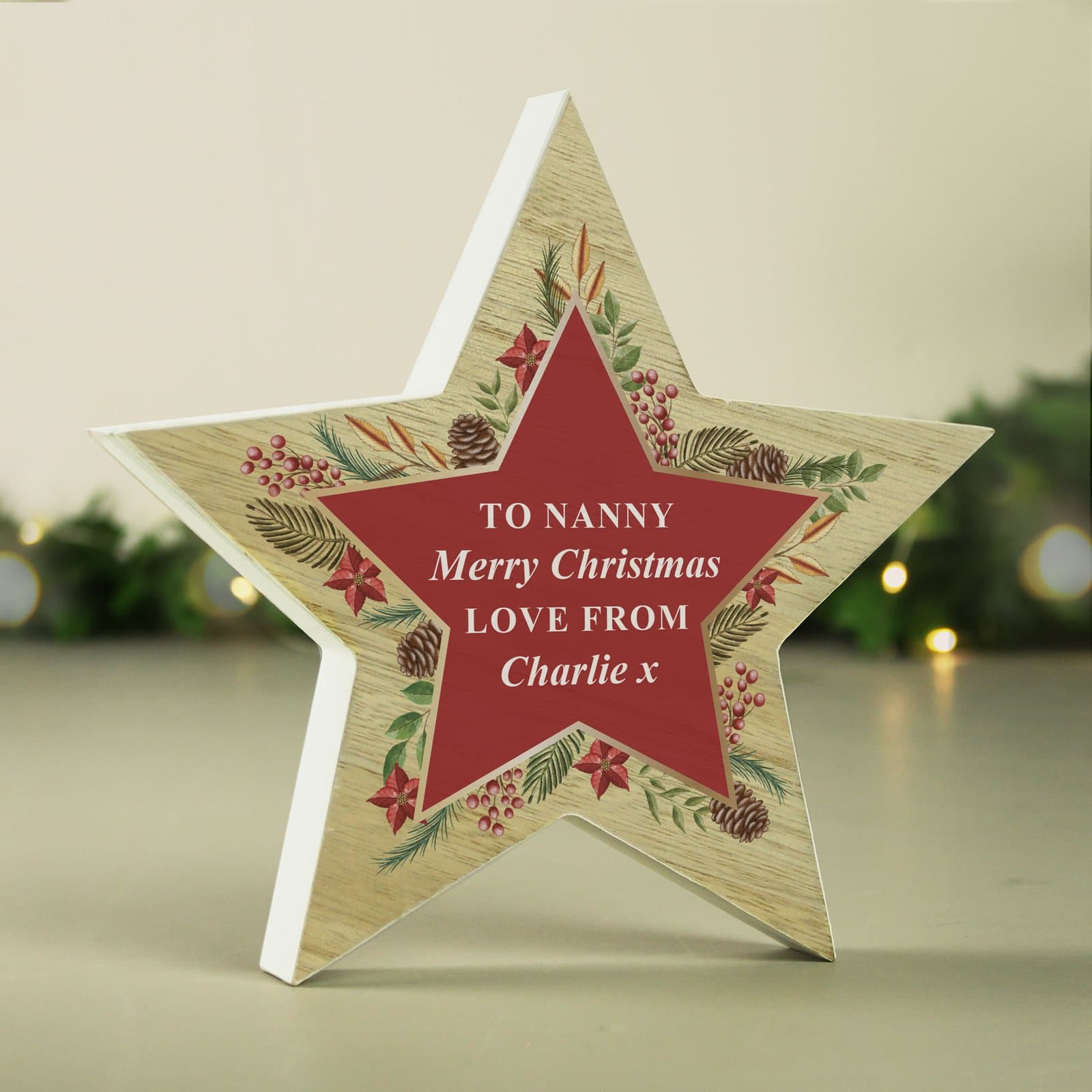 Wooden star ornament with a Christmas wreath design and personalised text