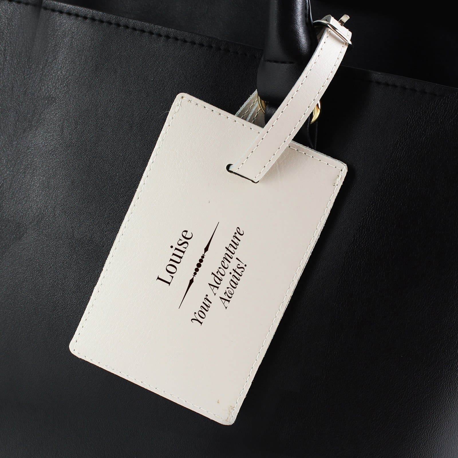 Cream leather luggage tag with a buckle and a personalised message