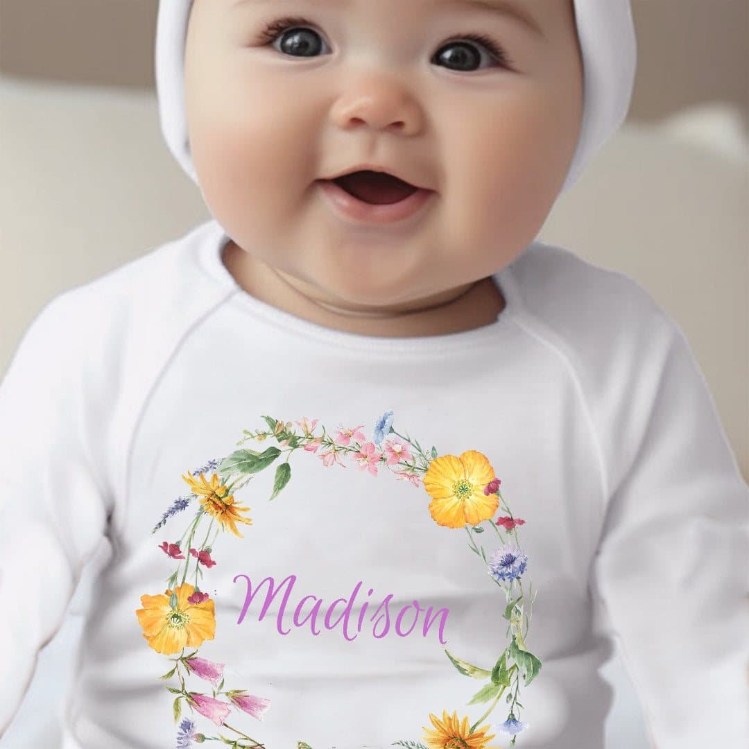Personalised colourful flowers baby outfit with a name printed on the design
