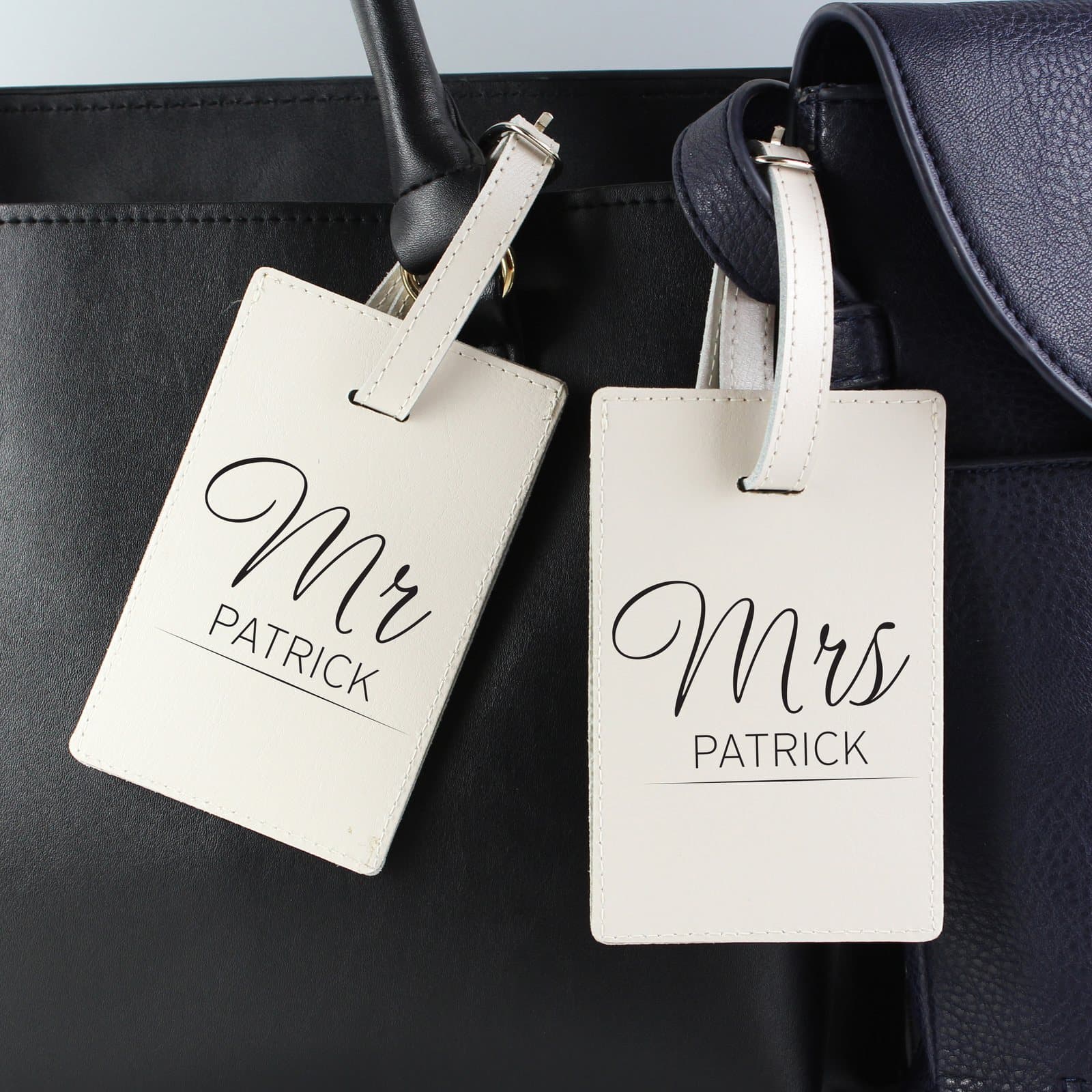 Pair of cream leather couples luggage tags with buckle fastening