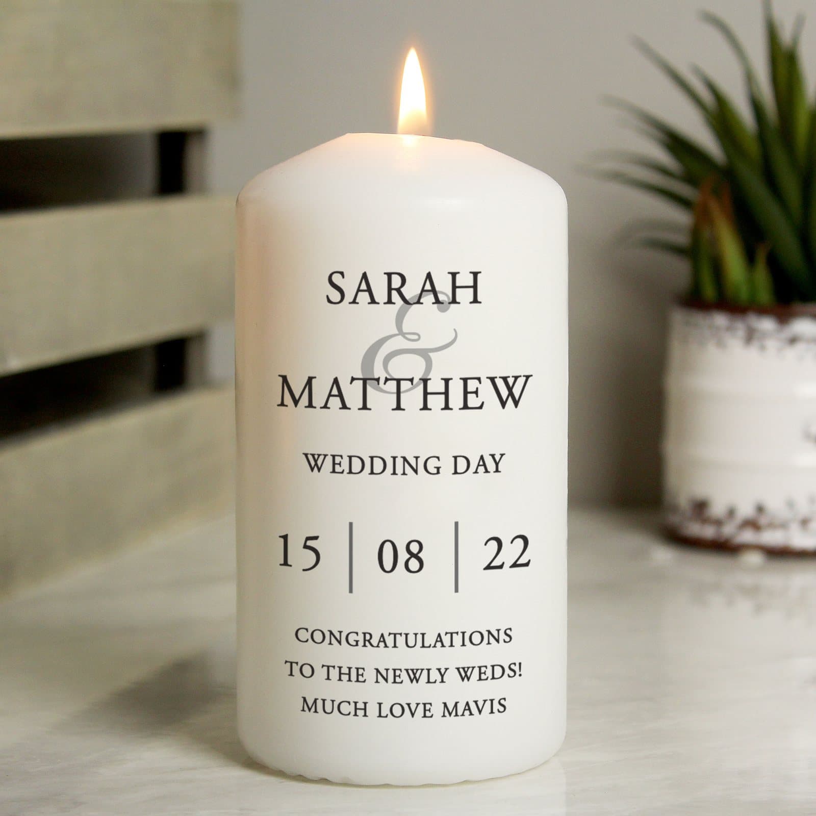Pillar candle personalised with two names, a date and a message