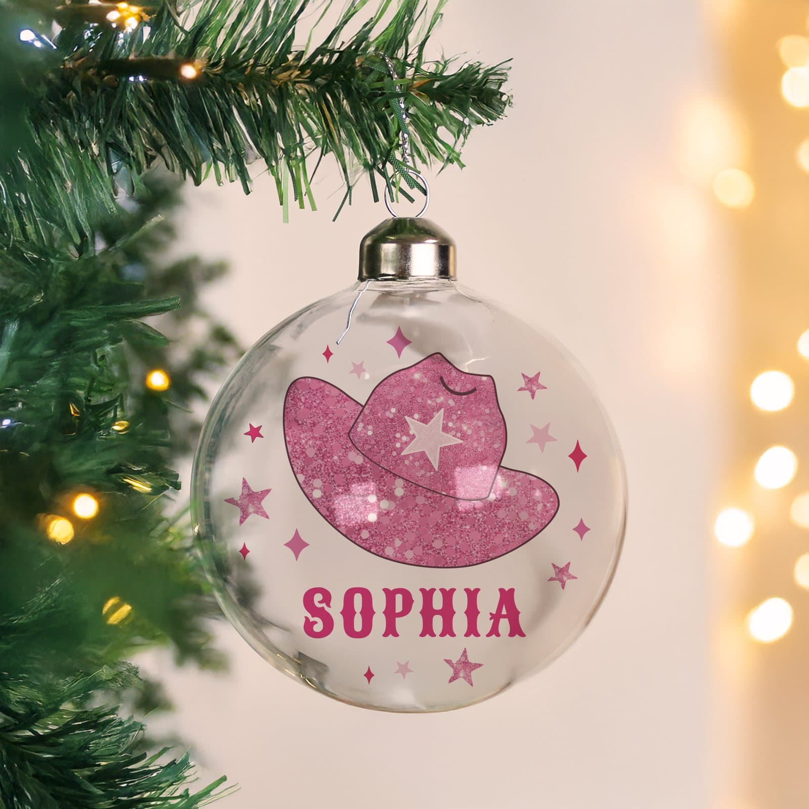 Pink glass Christmas bauble with a cowgirl hat design