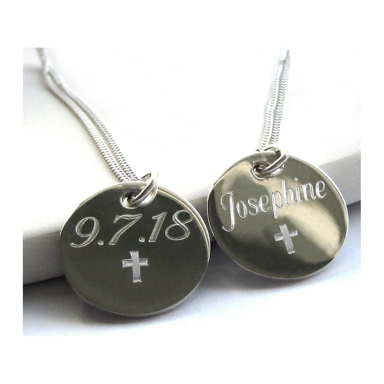 Silver cross necklace with a round engraved silver disc on a sterling silver chain