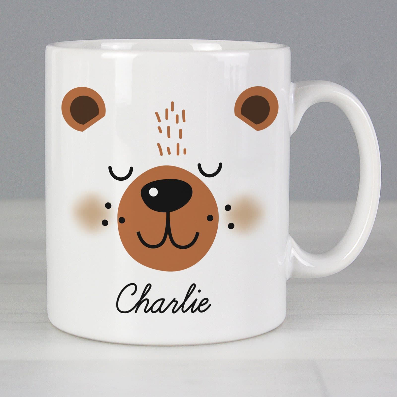 Ceramic mug with a cute bear face design, a name and a message