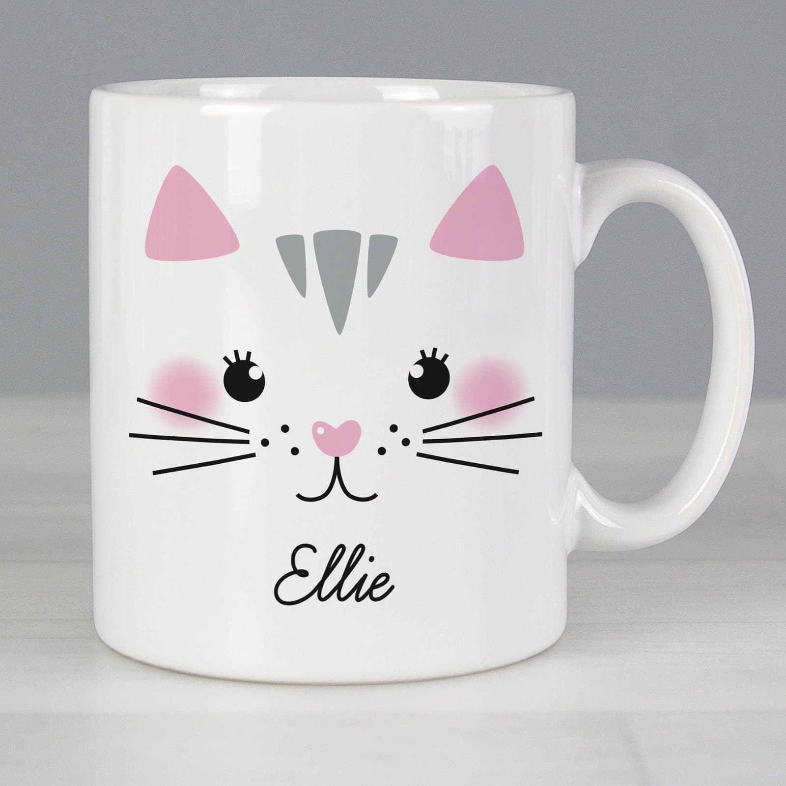 Ceramic mug with a cute cat face design, a name and a message