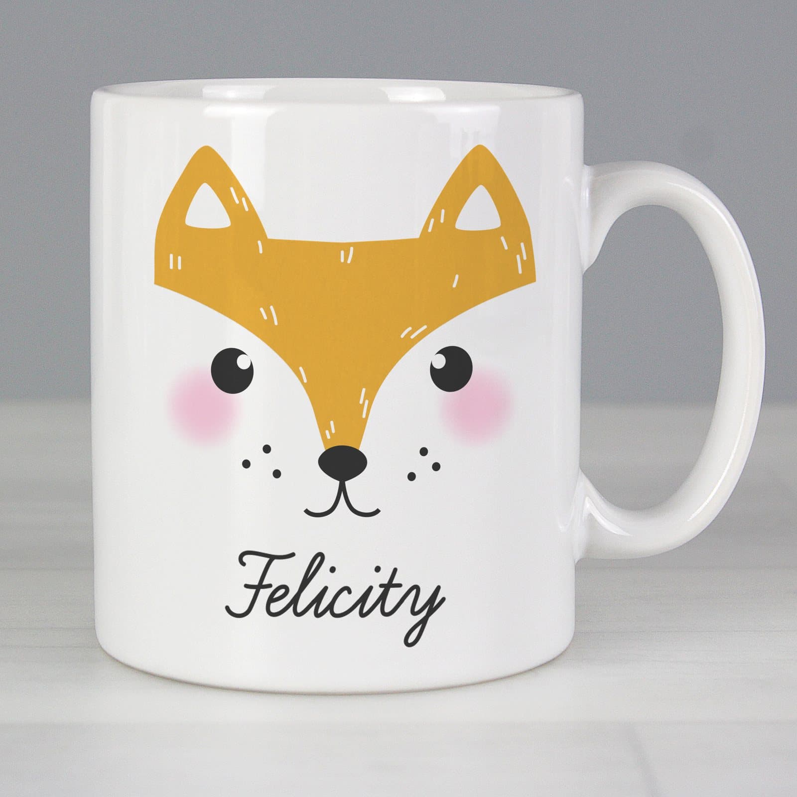 Ceramic mug with a cute fox face design, a name and a message
