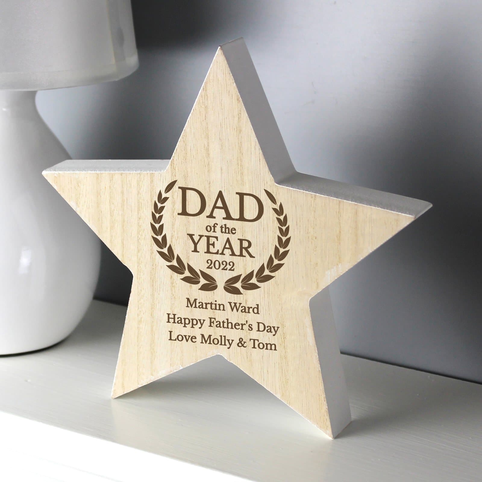 Rustic wooden star decoration reading Dad of the Year with a year and message