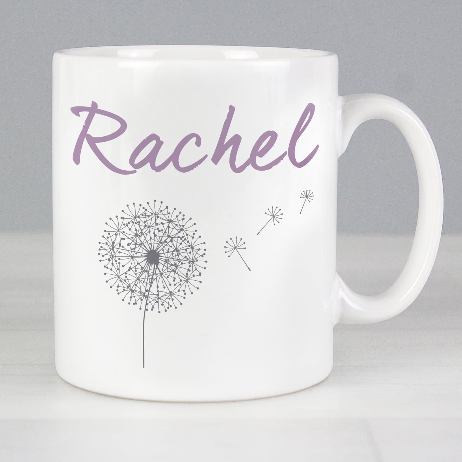 Ceramic mug styled with a dandelion and a name on the front
