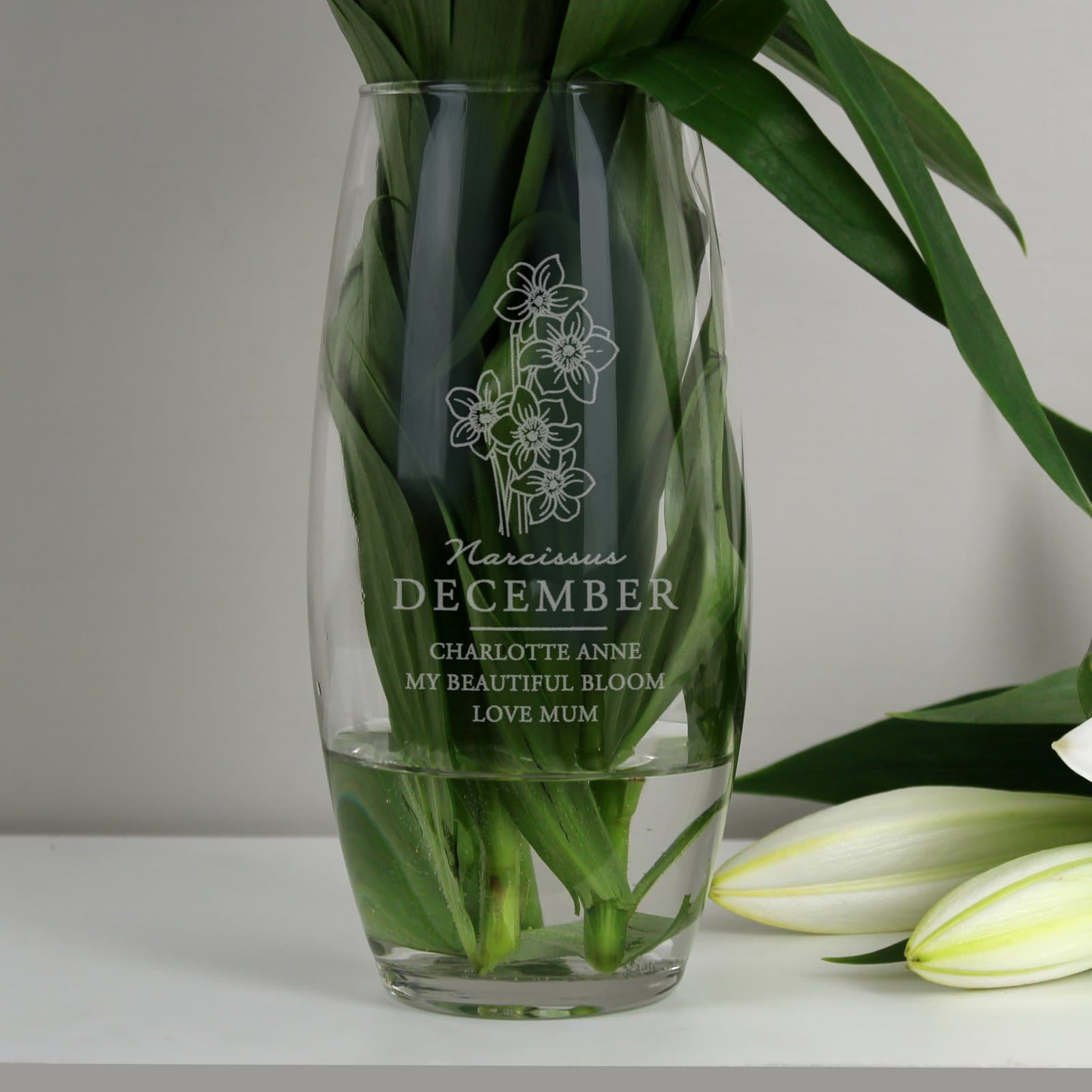 Glass bullet vase with a narcissus illustration and a personalised message
