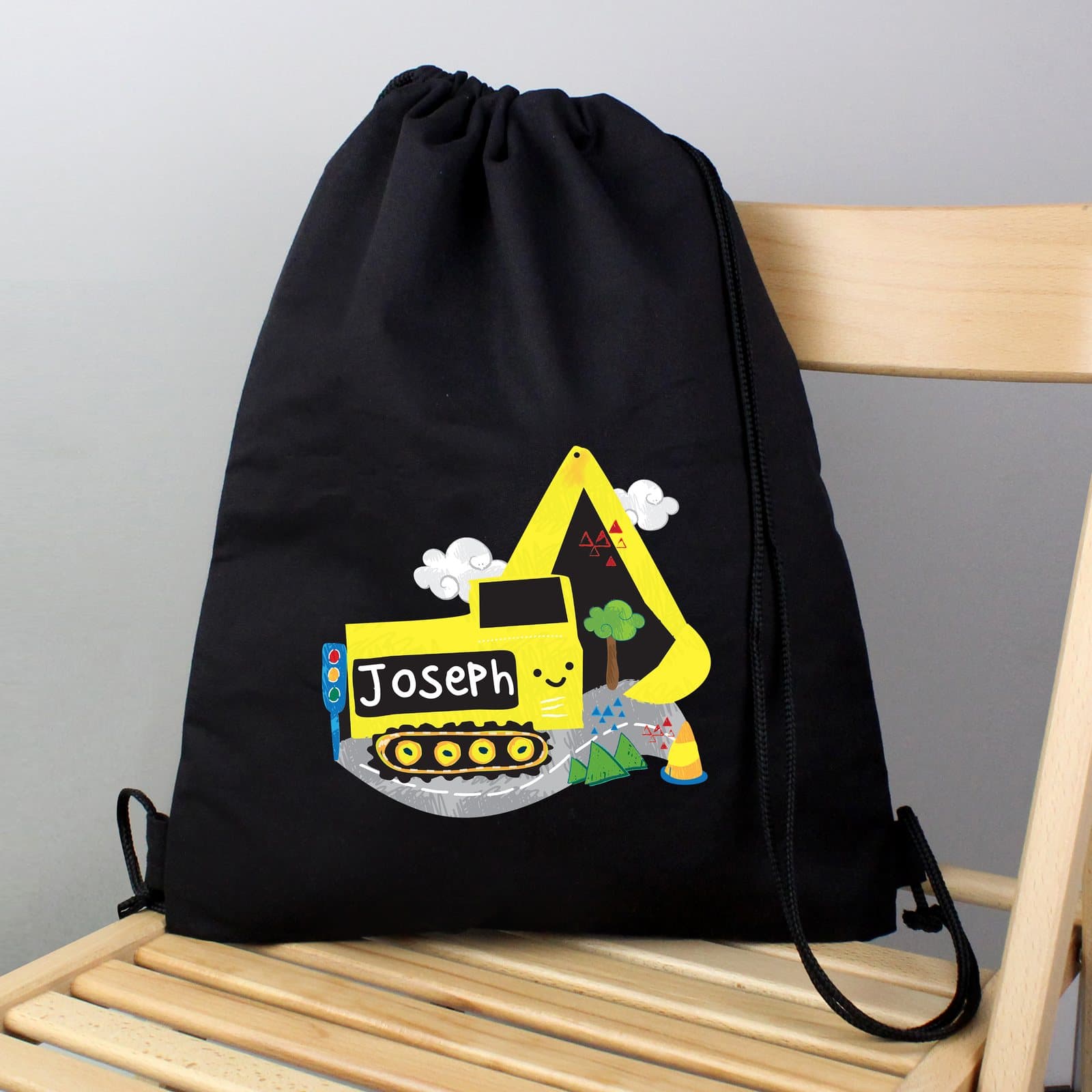 Black drawstring kit bag with a digger design and a personalised name