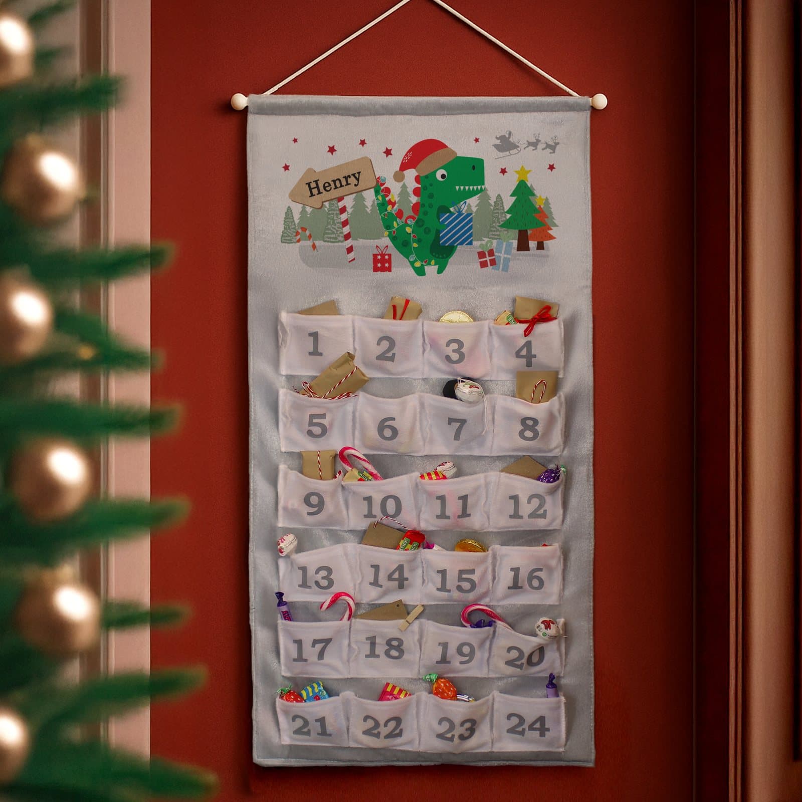 Dinosaur advent calendar with 24 numbered pockets and a personalised name