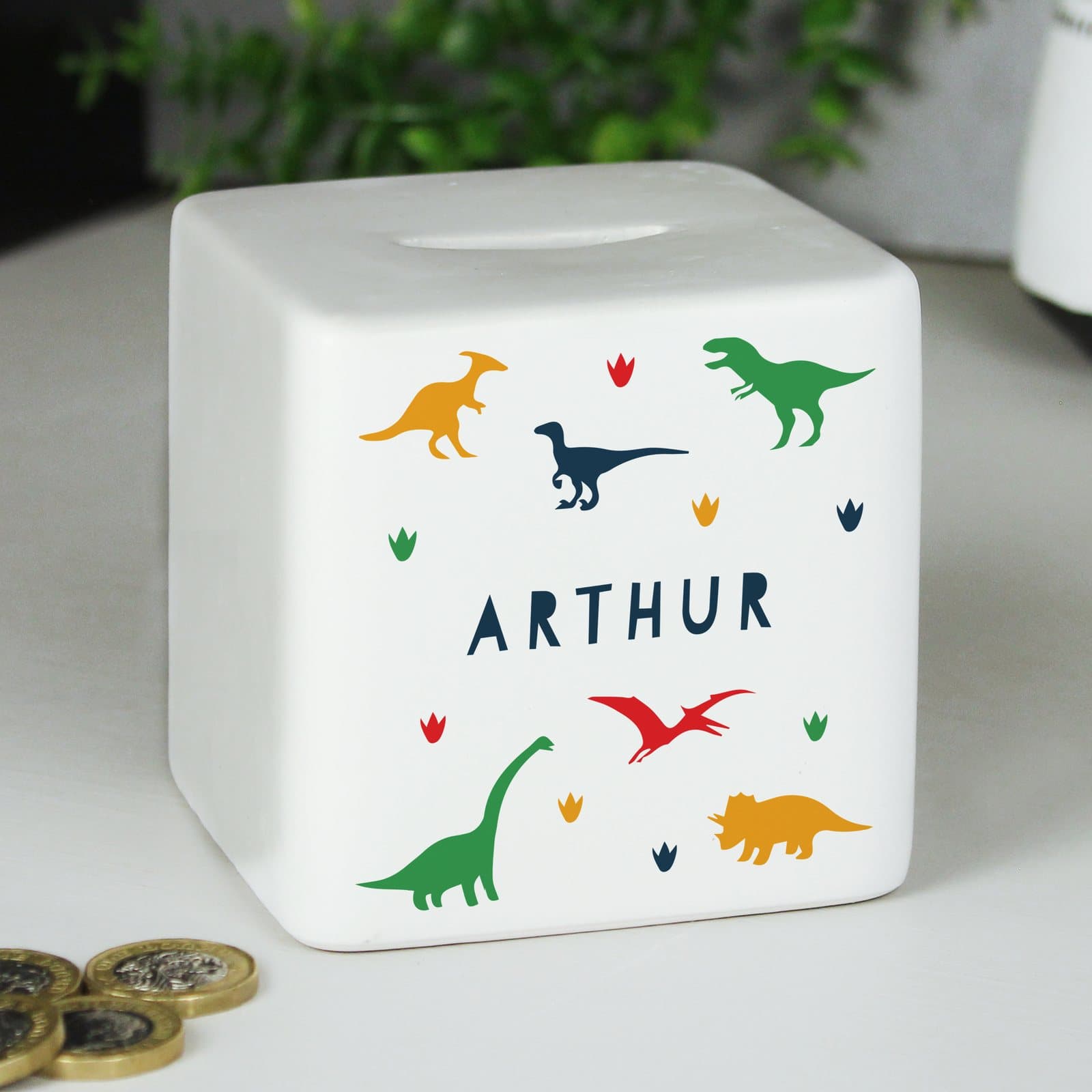 Square ceramic money box with a dinosaur design and a personalised name