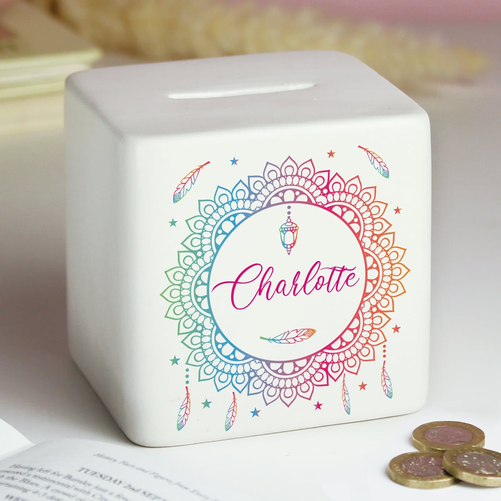 Square ceramic money box with a dreamcatcher design and a personalised name
