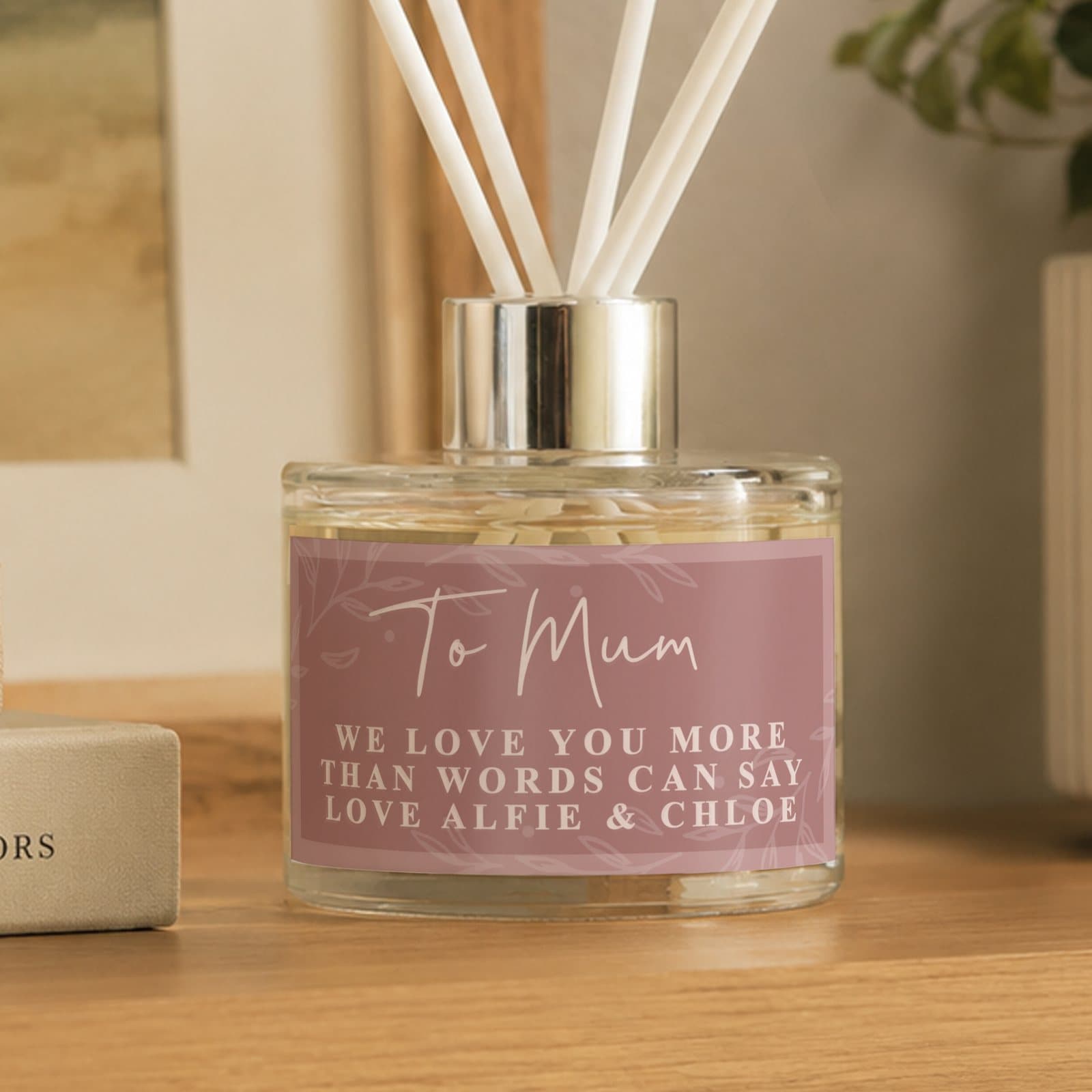 Personalised dusky pink glass reed diffuser with four lines of text